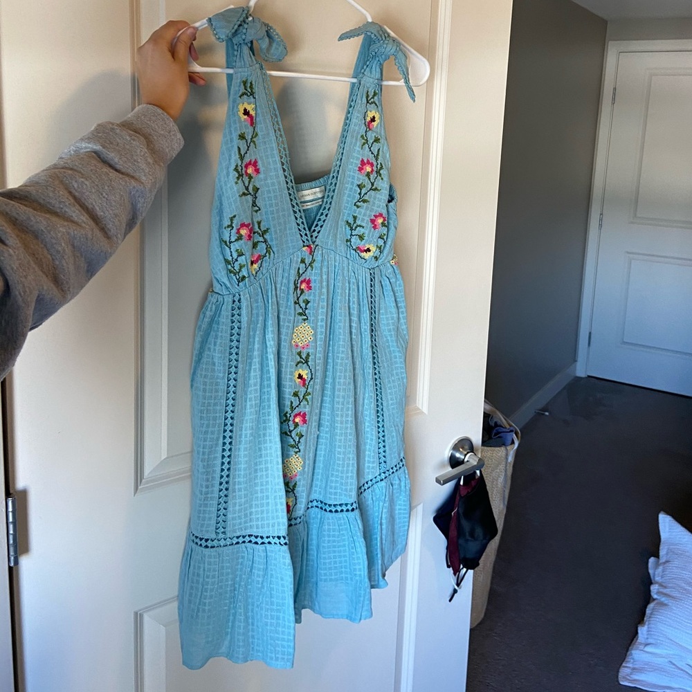 Light blue sun dress with flower details.